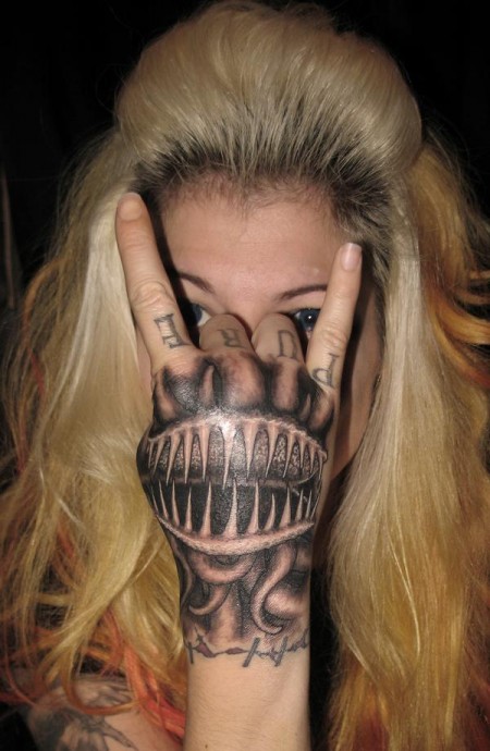 Tatuaje de una mandibula con tentaculos en la mano