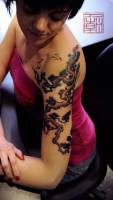 Tatuaje de un árbol chino en el brazo
