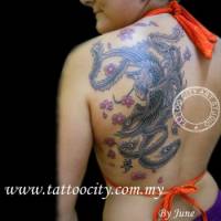 Tatuaje de un fénix con flores volando en la espalda de una chica